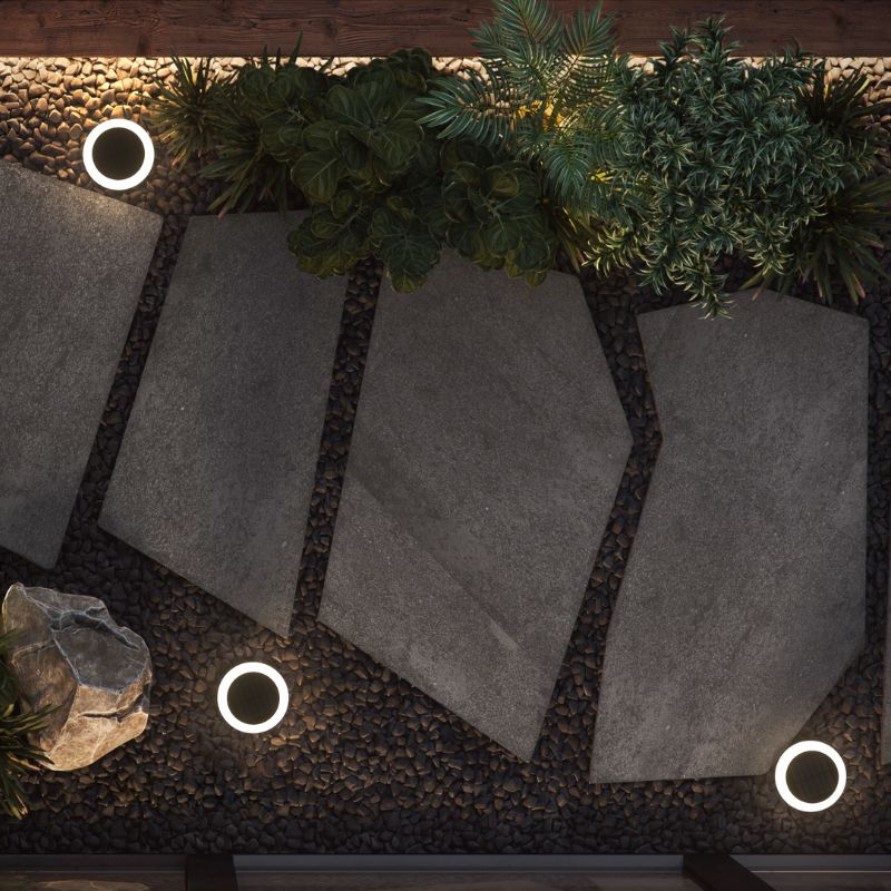 Ningbo Hanyuan smart Tuya floor lamp with black moon design, illuminating an outdoor pathway with plants and stone tiles.