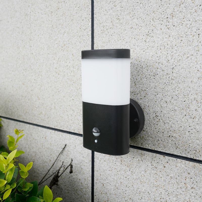 A black indoor wall lamp with a white light diffuser, featuring a sleek design and motion sensor for efficient lighting.