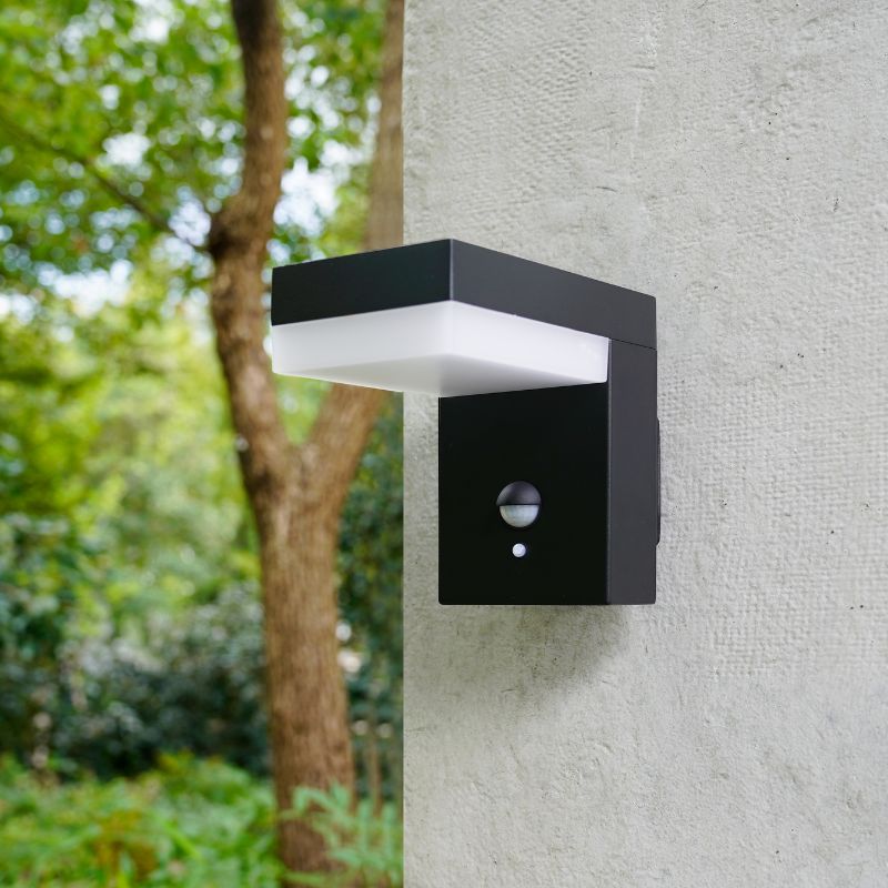 A sleek black indoor wall lamp with a modern design, featuring a motion sensor and a white LED light, perfect for both functional and decorative lighting.